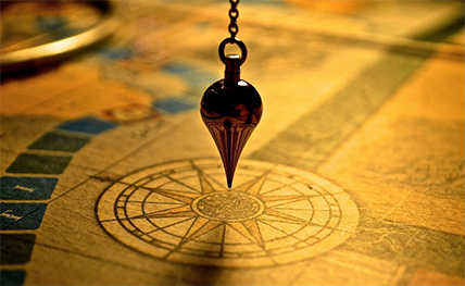Pendulum hovering over a compass rose